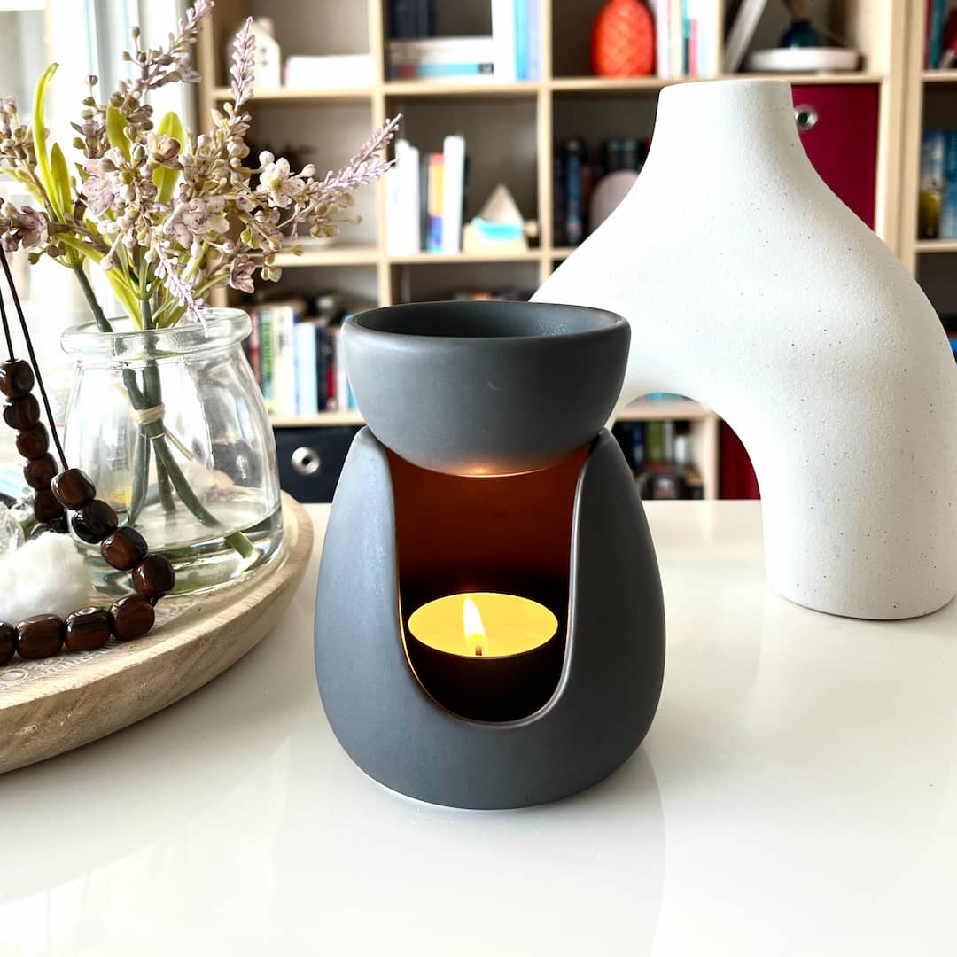 My black Dog charcoal ceramic tealight burner sitting on a desk