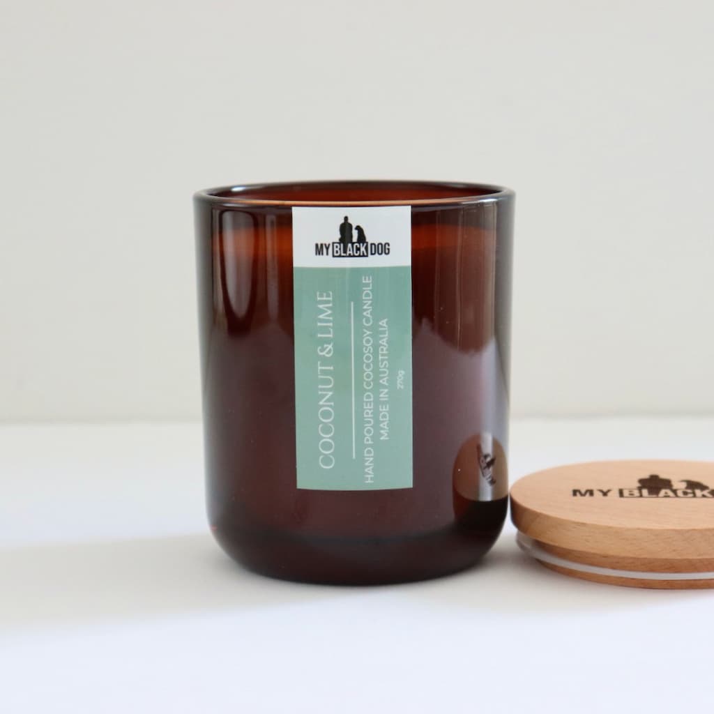My Black Dog Coconut & Lime CocoSoy Candle in an amber jar with a natural lid