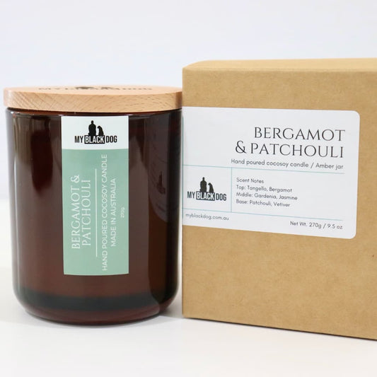 My Black Dog Bergamot & Patchouli CocoSoy Candle in an amber jar with natural timber lid and box
