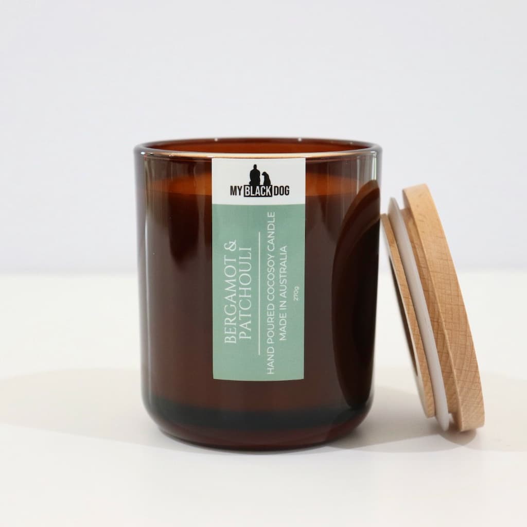 My Black Dog Bergamot & Patchouli CocoSoy Candle in an amber jar with natural timber lid