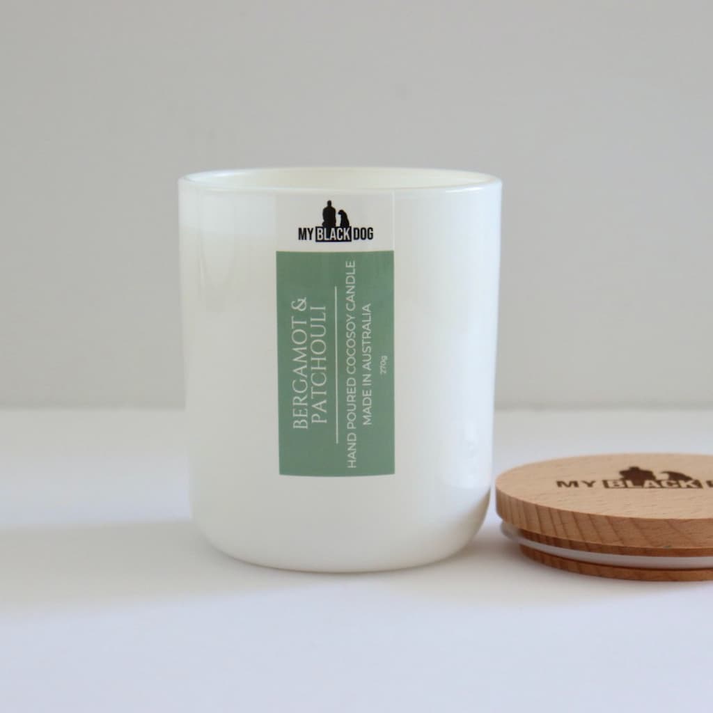 My Black Dog Bergamot & Patchouli CocoSoy Candle in a white jar with a timber lid