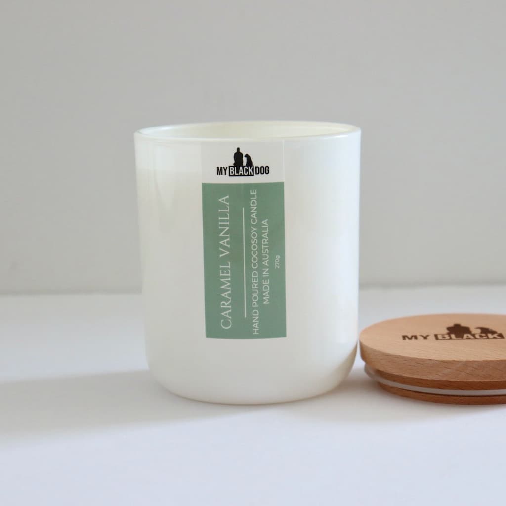 My Black Dog Caramel Vanilla CocoSoy Candle in a white jar with timber lid