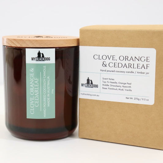 My Black Dog Clove, Orange & Cedarleaf CocoSoy Candle in an amber jar with a natural timber lid and box