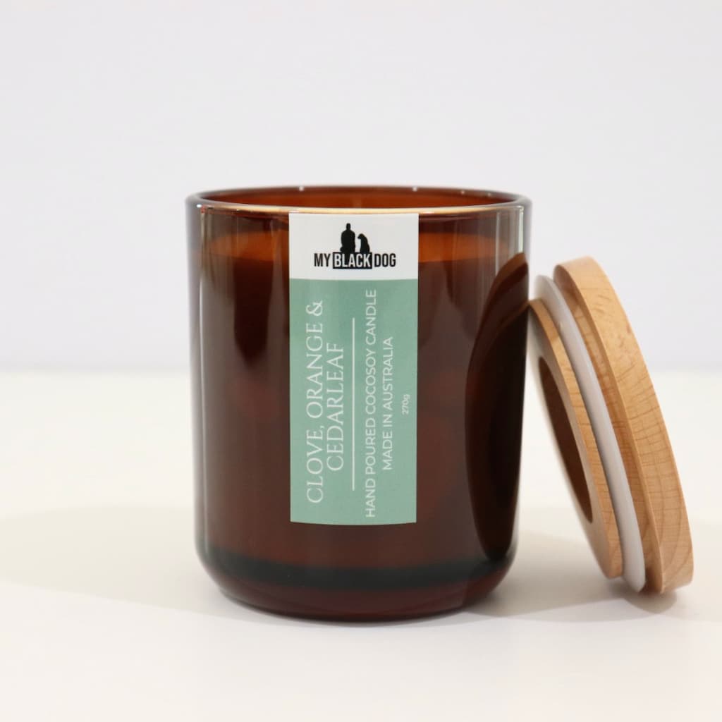 My Black Dog Clove, Orange & Cedarleaf CocoSoy Candle in an amber jar with a natural timber lid