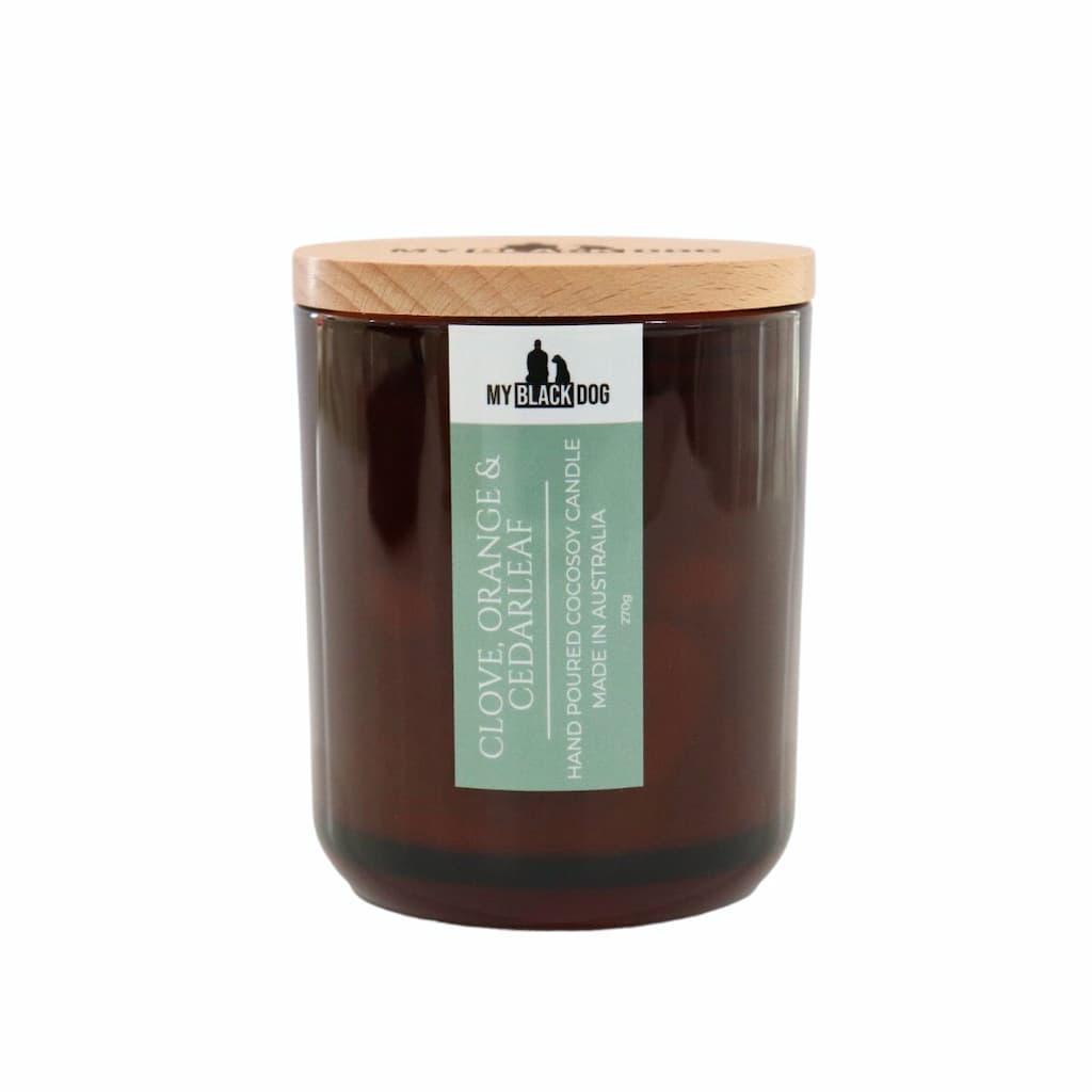 My Black Dog Clove, Orange & Cedarleaf CocoSoy Candle in an amber jar with a natural timber lid