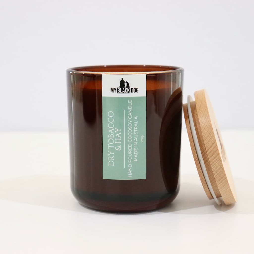 My Black Dog Dry Tobacco & Hay CocoSoy Candle in an amber jar with a natural timber lid