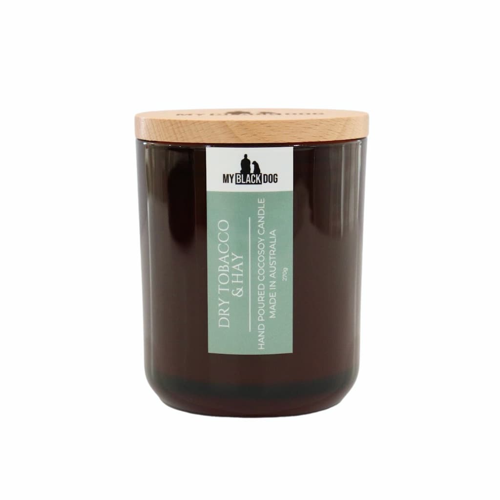 My Black Dog Dry Tobacco & Hay CocoSoy Candle in an amber jar with a natural timber lid