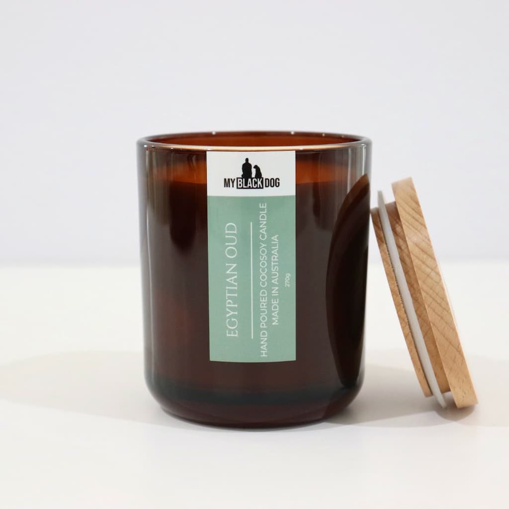 My Black Dog Egyptian Oud CocoSoy Candle in an amber jar with a natural timber lid