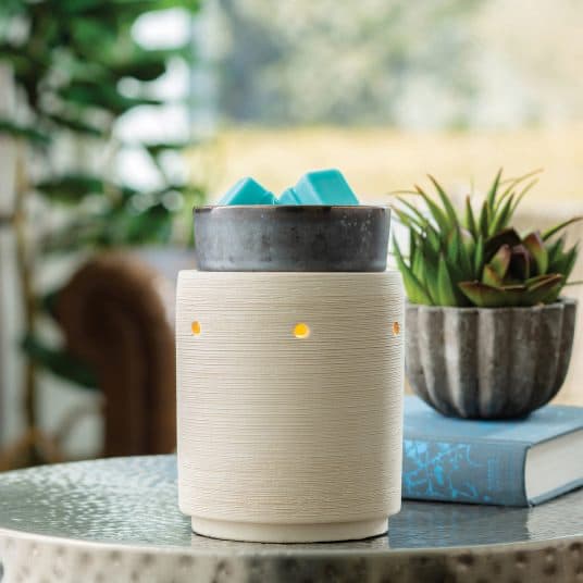 Iron & Clay Illumination Wax Melt Warmer sitting on coffee table with planter and book