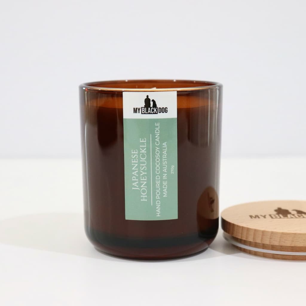 My Black Dog Japanese Honeysuckle CocoSoy Candle in an amber jar with a natural timber lid