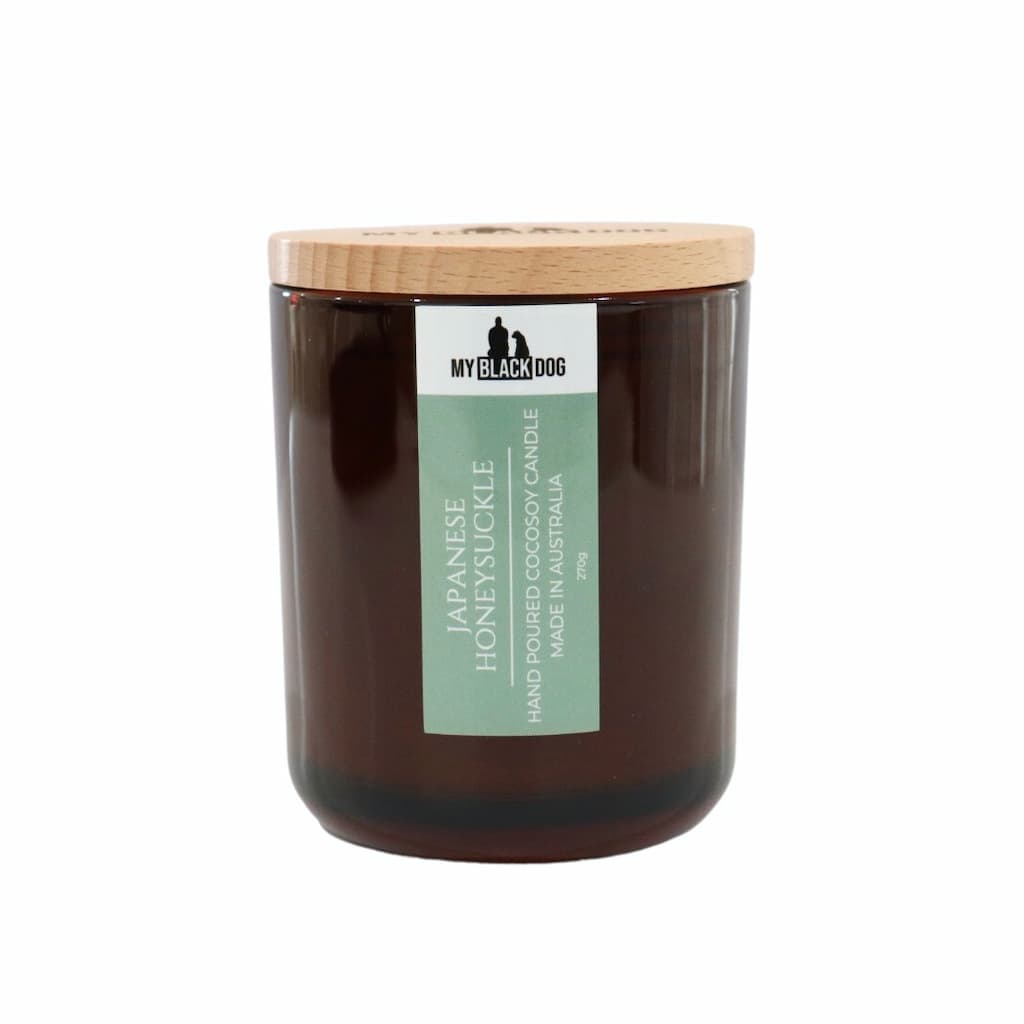 My Black Dog Japanese Honeysuckle CocoSoy Candle in an amber jar with a natural timber lid