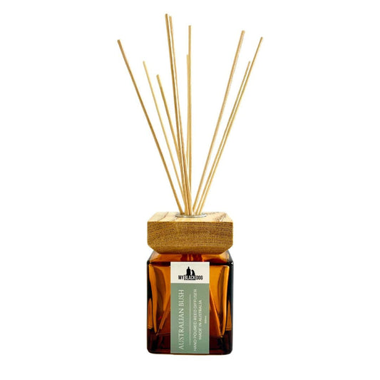 Reed diffuser with wooden cap and amber  glass bottle on a white background