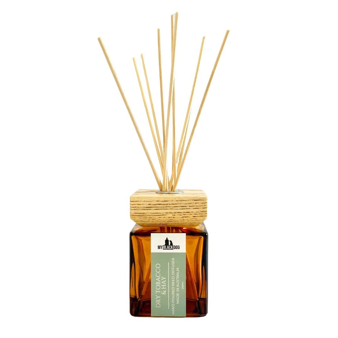 Reed diffuser with wooden sticks and a amber bottle on a white background