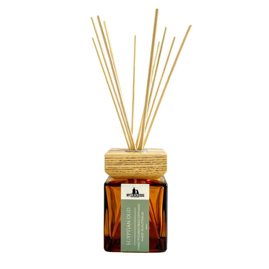 Reed diffuser with wooden cap and sticks on a white background