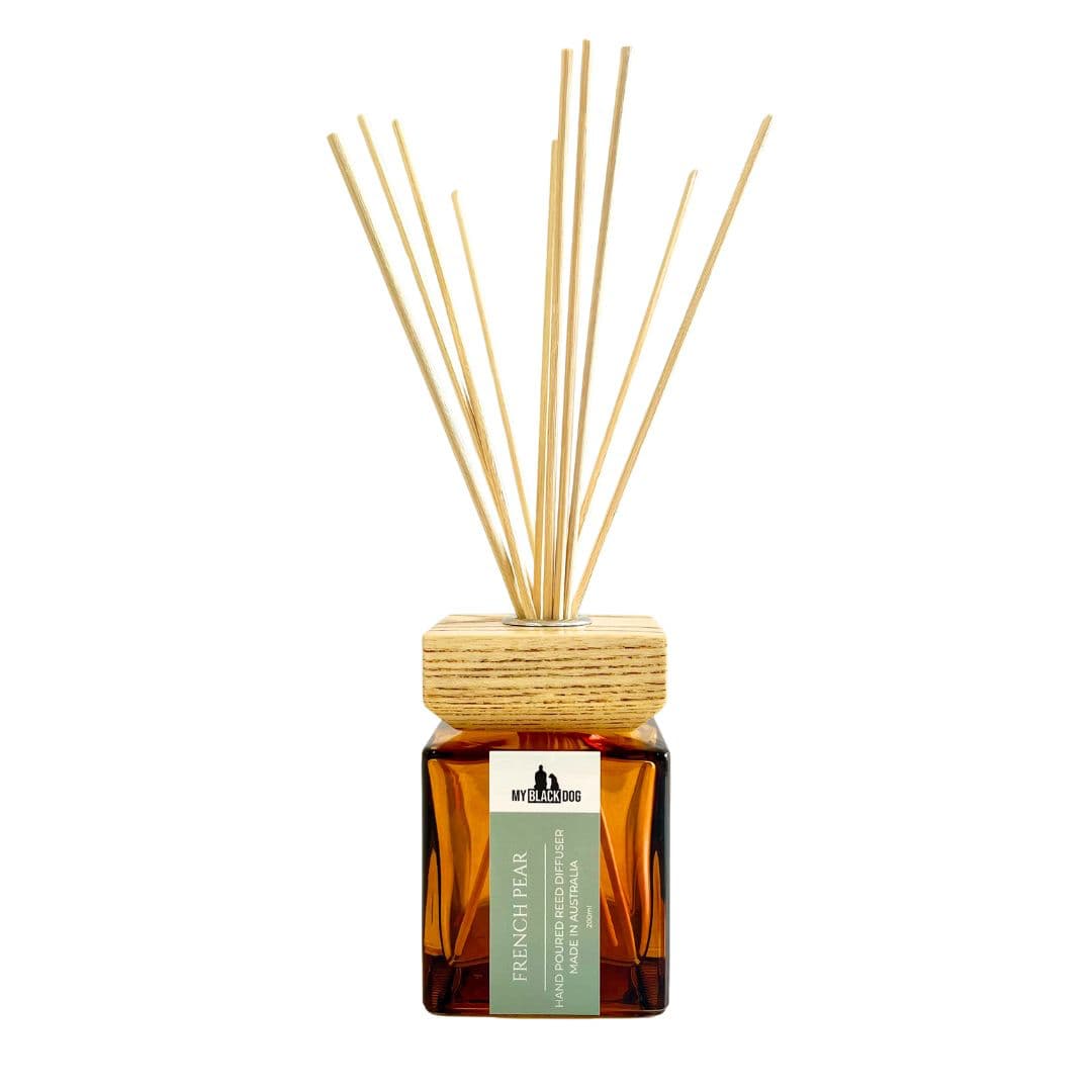 French pear scented reed diffuser with wooden sticks on a white background