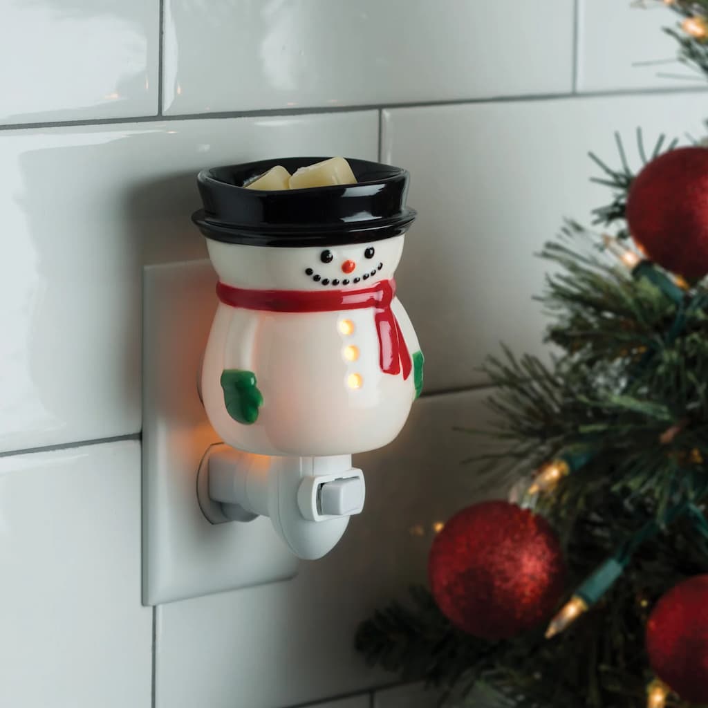 Frosty the Snowman wall plug-in wax melt warmer with Christmas tree in the background