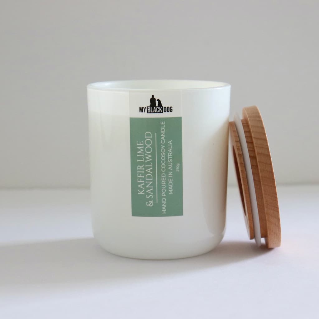 My Black Dog Kaffir Lime & Sandalwood CocoSoy Candle in a white jar with natural timber lid