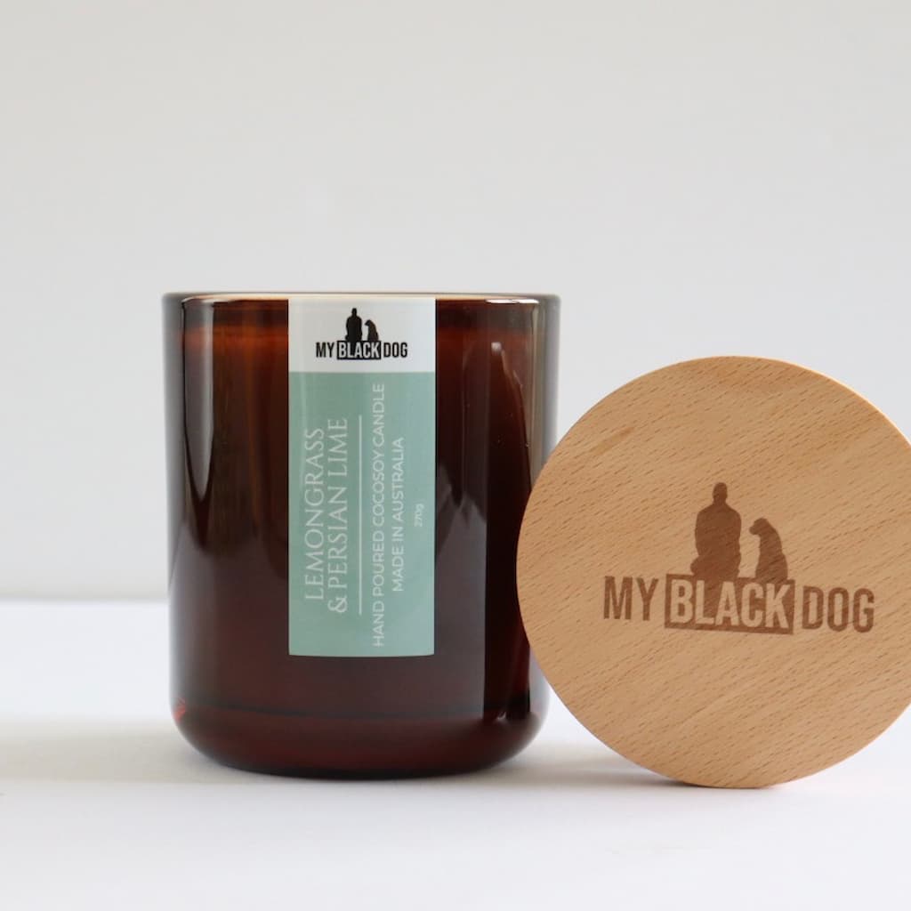 My Black Dog Lemongrass & Persian Lime CocoSoy Candle in an amber jar with wooden lid