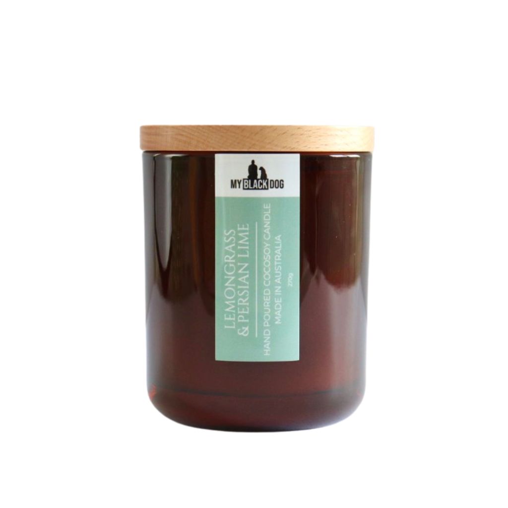 My Black Dog Lemongrass & Persian Lime CocoSoy Candle in an amber jar with wooden lid