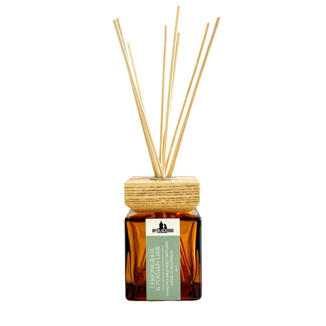 My Black Dog lemongrass and Persian lime scented reed diffuser in a square amber bottle with a square wooden lid on a white background.
