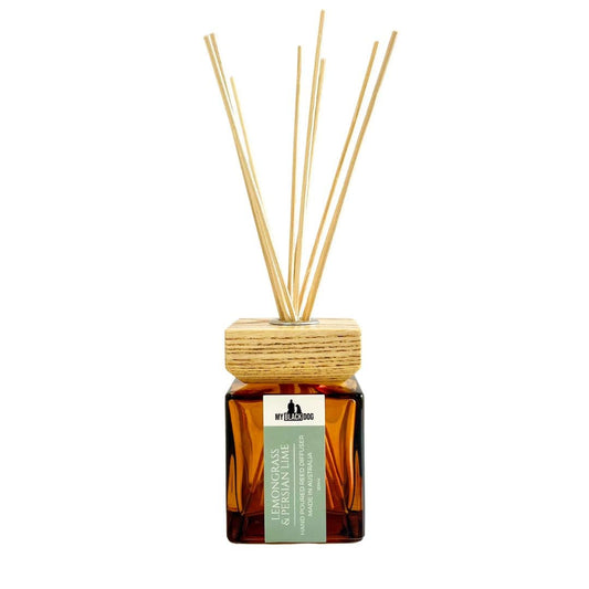 My Black Dog lemongrass and Persian lime scented reed diffuser in a square amber bottle with a square wooden lid on a white background.