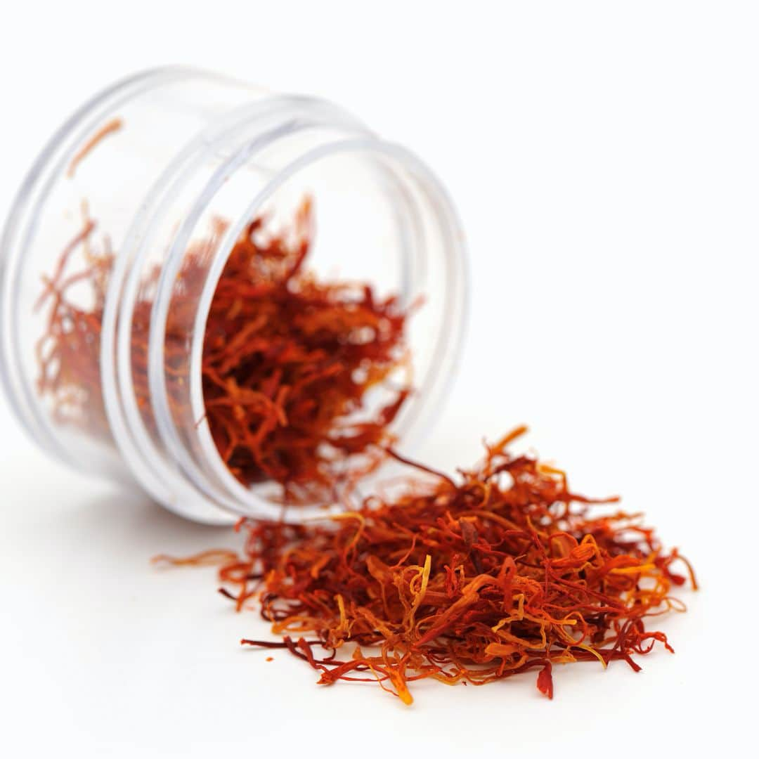 Saffron spilling out of a clear jar