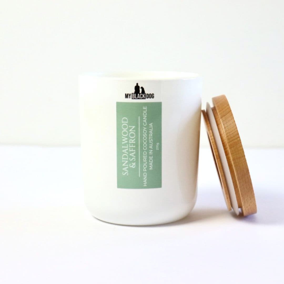 My Black Dog Sandalwood & Saffron CocoSoy Candle in a white jar with a timber lid