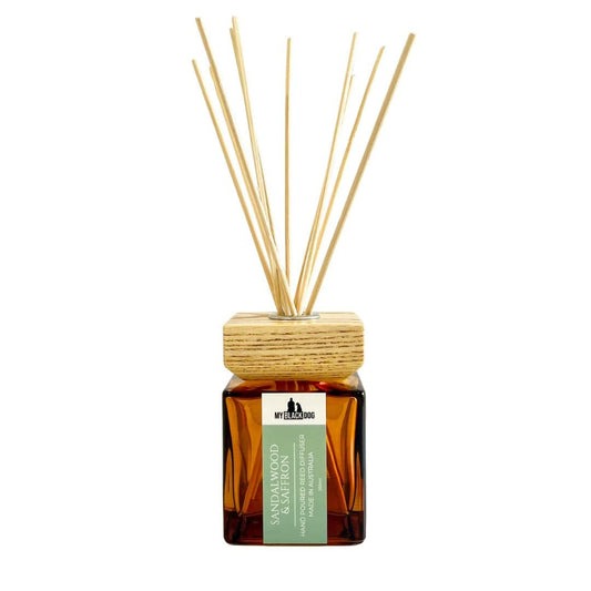 My Black Dog sandalwood and saffron scented reed diffuser in a square amber bottle with wooden cap on a white background