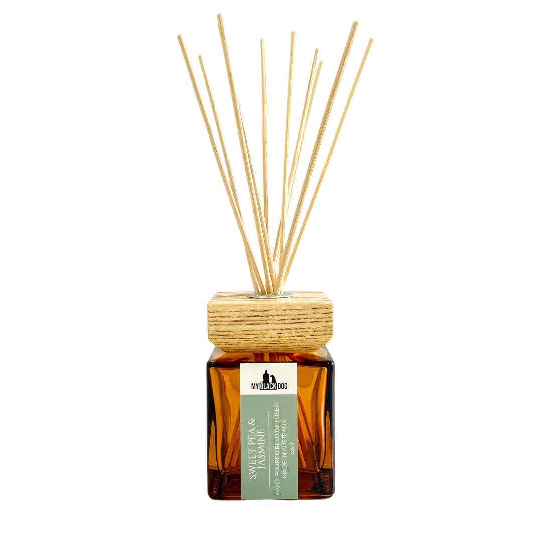 My Black Dog Sweet Pea & Jasmine scented reed diffuser with wooden sticks on a white background.