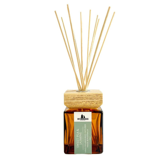 My Black Dog Sweet Pea & Jasmine scented reed diffuser with wooden sticks on a white background.