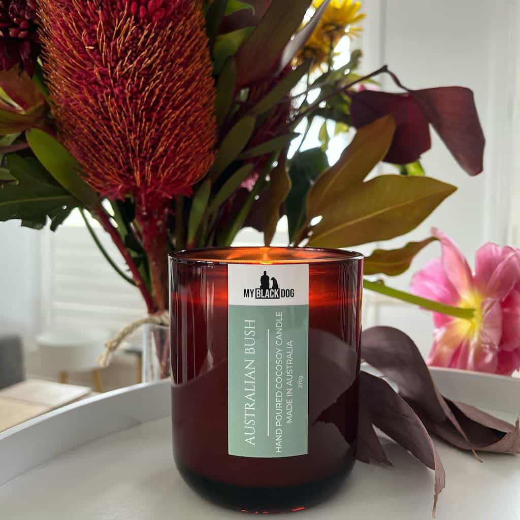 My Black Dog Australian Bush CocoSoy Candle on tray with native flowers