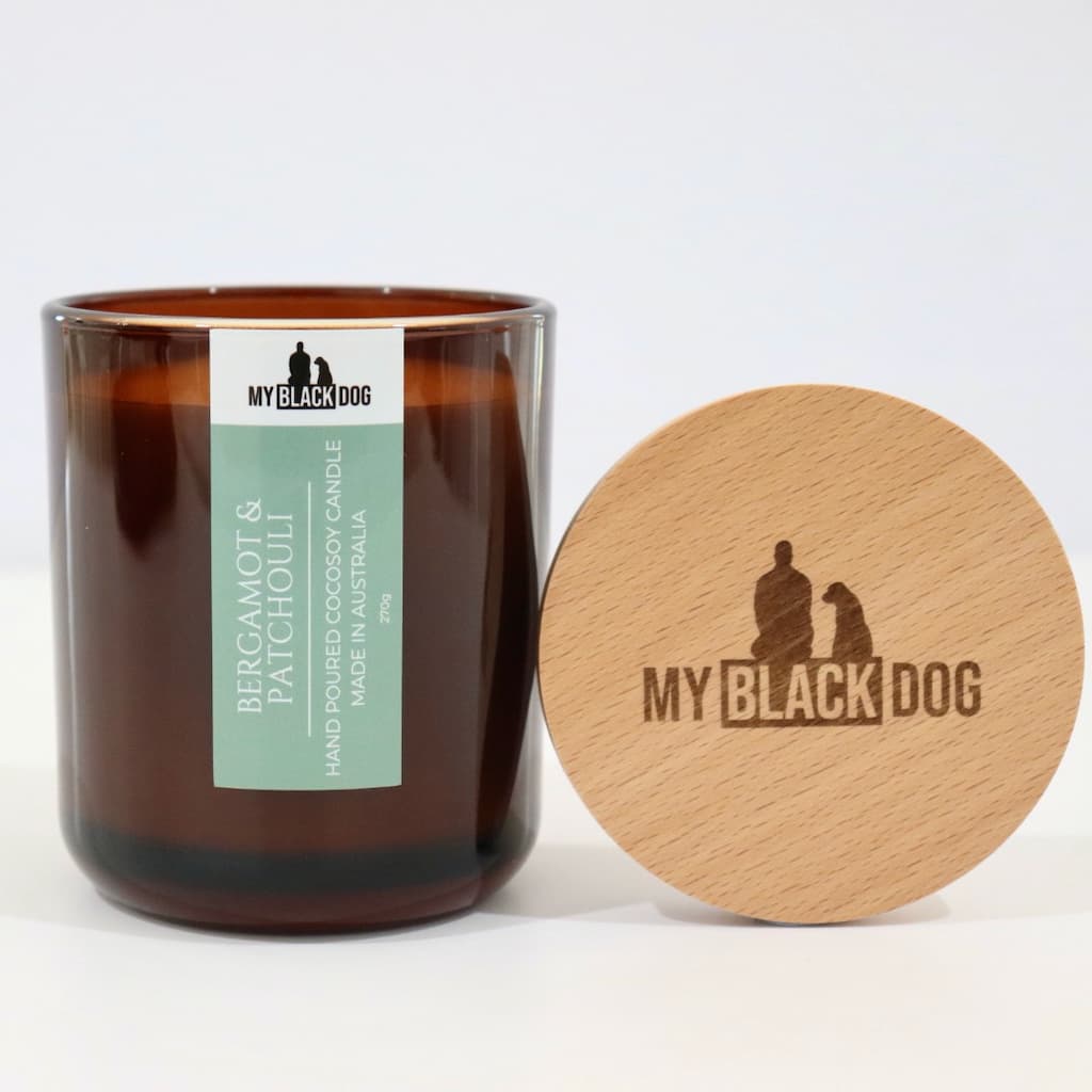My Black Dog Bergamot & Patchouli CocoSoy Candle in an amber jar with natural timber lid
