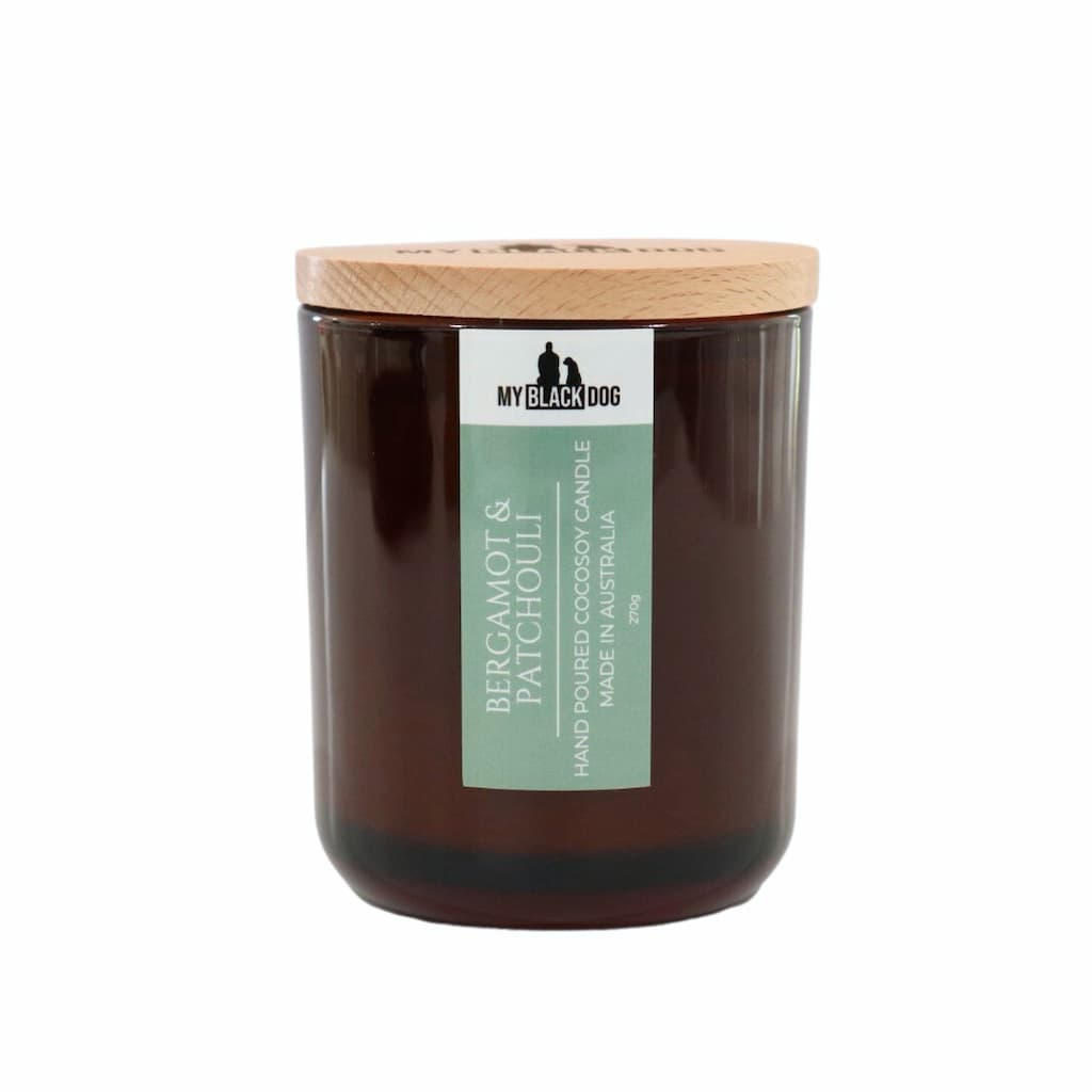 My Black Dog Bergamot & Patchouli CocoSoy Candle in an amber jar with natural timber lid