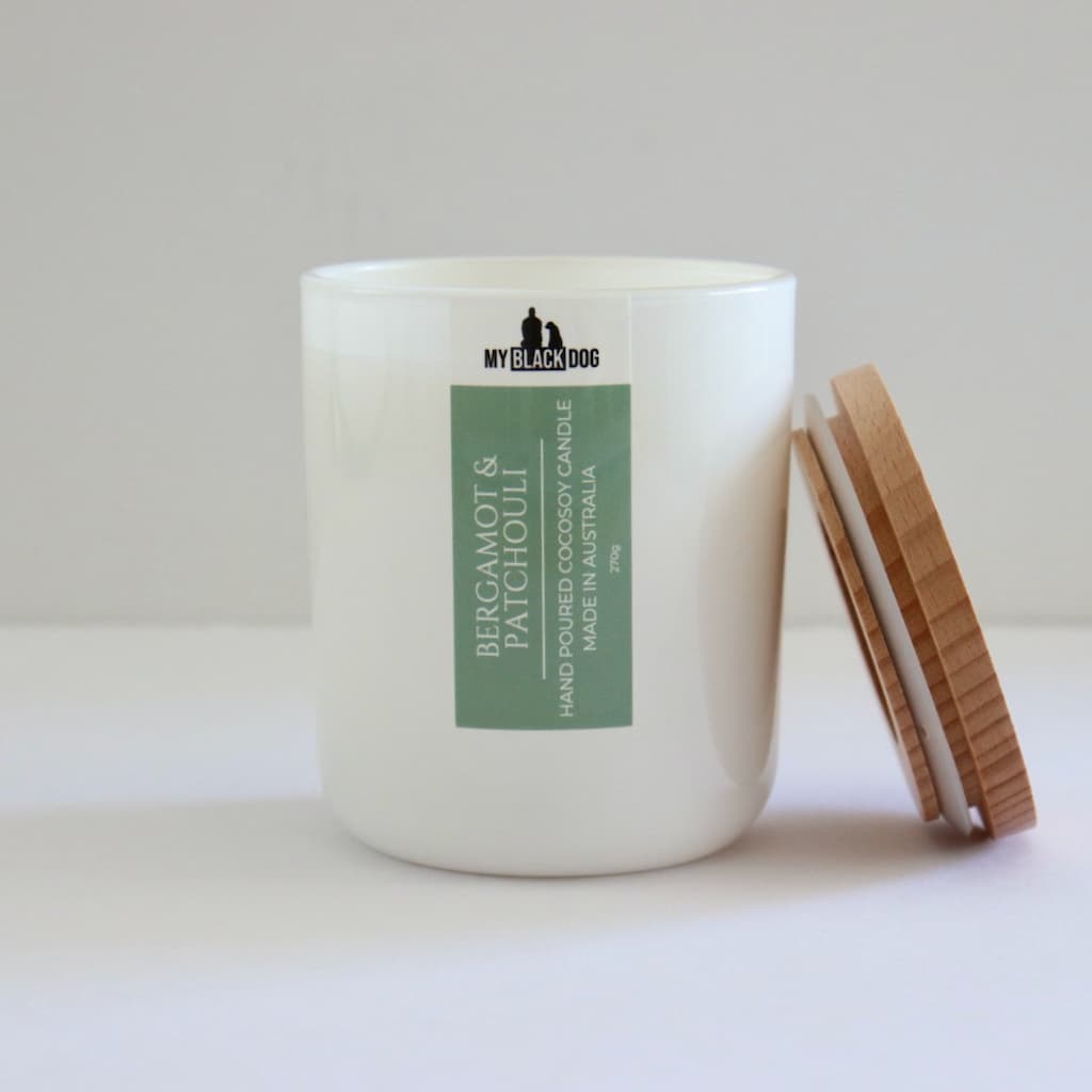 My Black Dog Bergamot & Patchouli CocoSoy Candle in a white jar with a timber lid