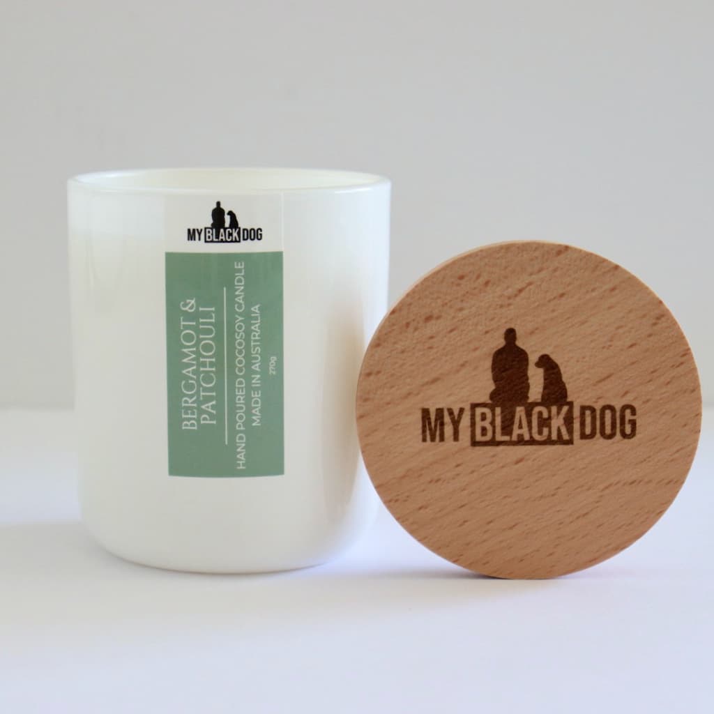 My Black Dog Bergamot & Patchouli CocoSoy Candle in a white jar with a timber lid