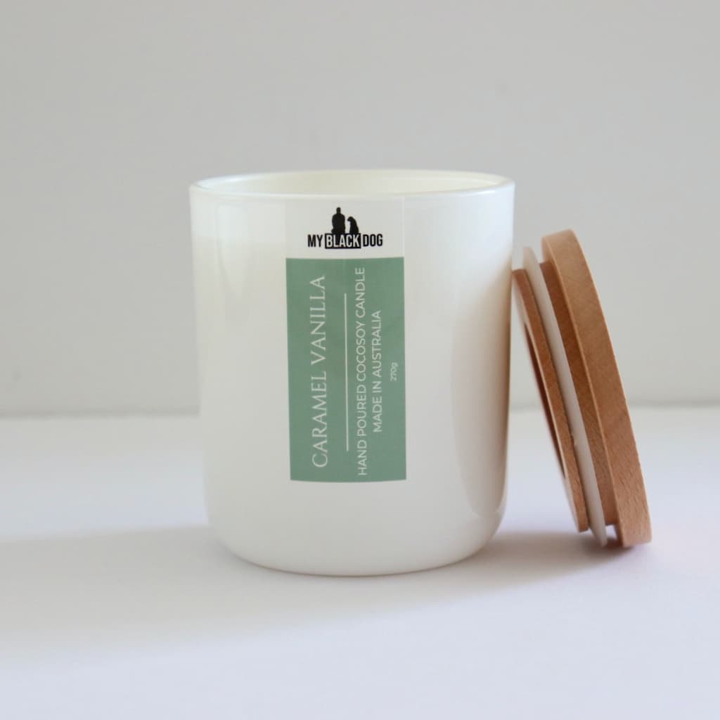 My Black Dog Caramel Vanilla CocoSoy Candle in a white jar with timber lid