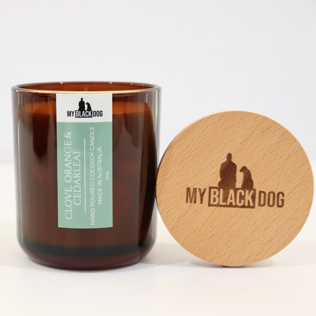 My Black Dog Clove, Orange & Cedarleaf CocoSoy Candle in an amber jar with a natural timber lid