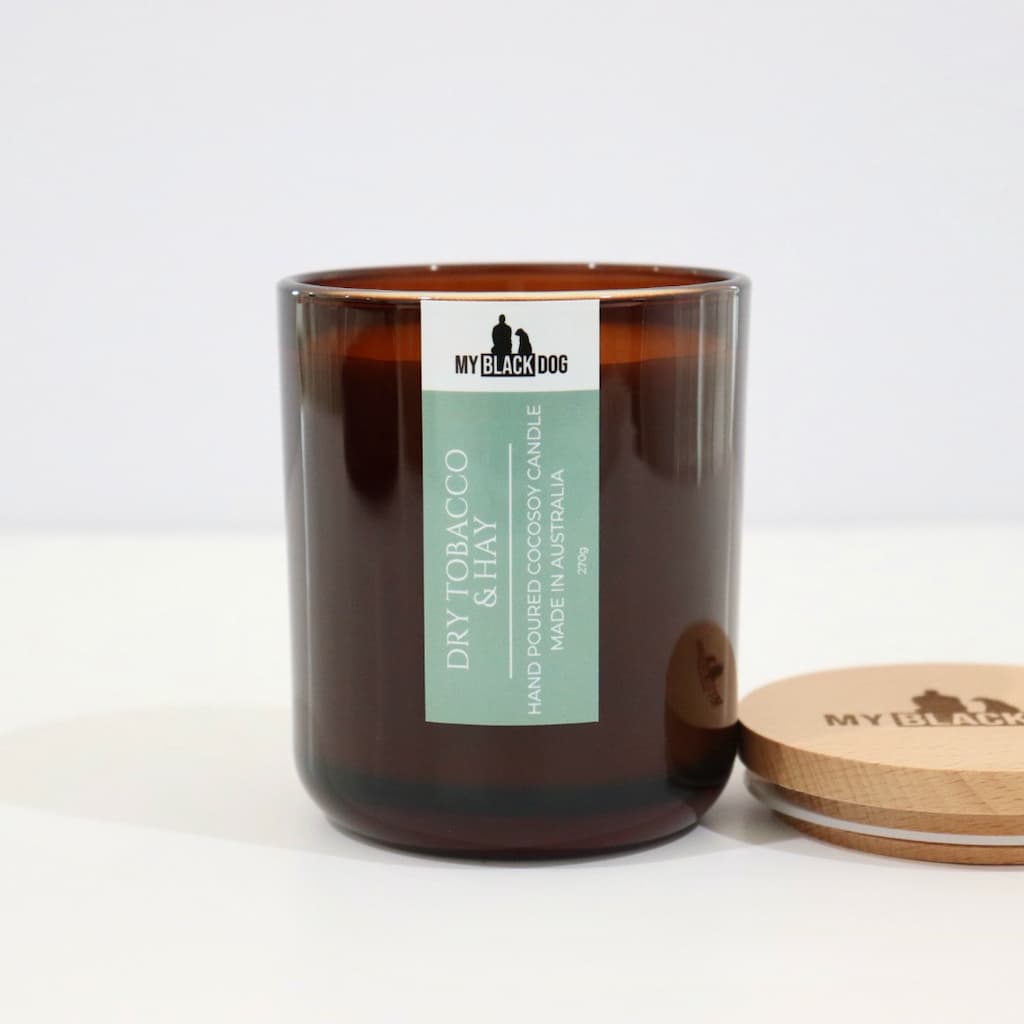 My Black Dog Dry Tobacco & Hay CocoSoy Candle in an amber jar with a natural timber lid