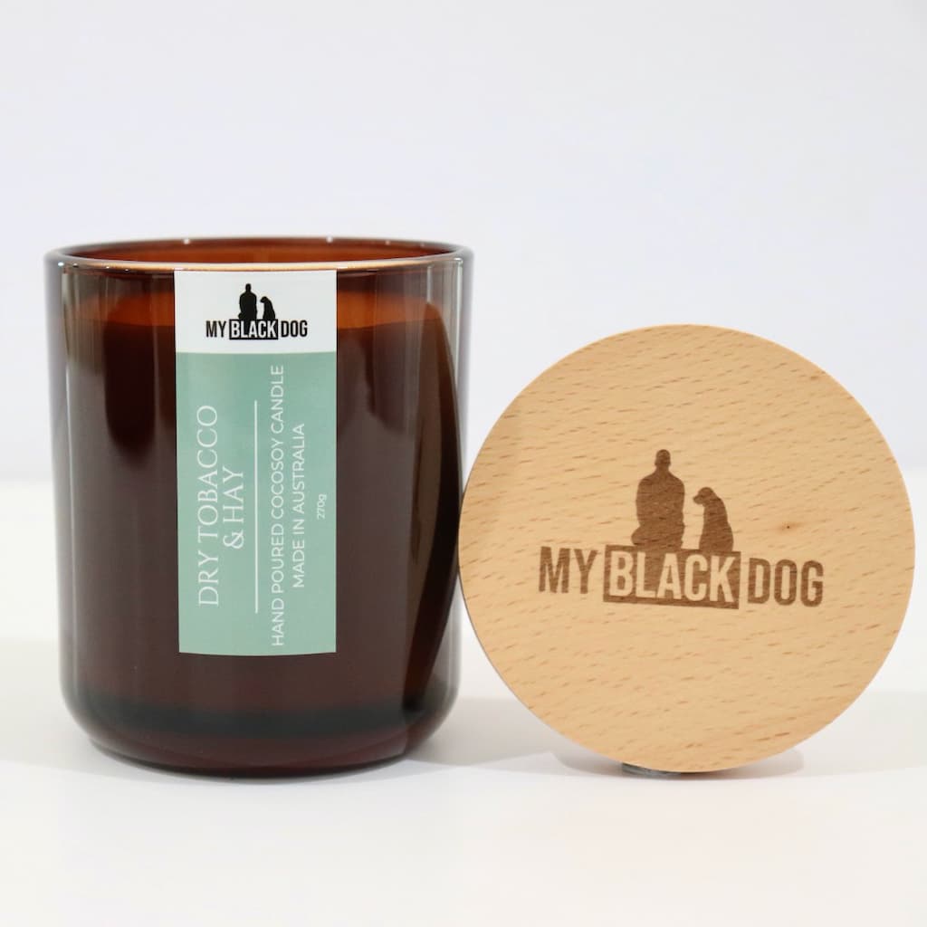 My Black Dog Dry Tobacco & Hay CocoSoy Candle in an amber jar with a natural timber lid