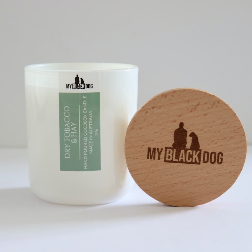 My Black Dog Dry Tobacco & Hay CocoSoy Candle in a white jar with timber lid