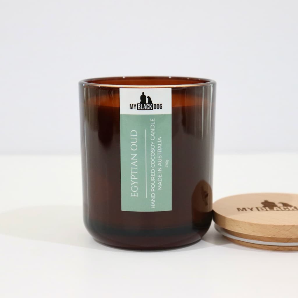 My Black Dog Egyptian Oud CocoSoy Candle in an amber jar with a natural timber lid