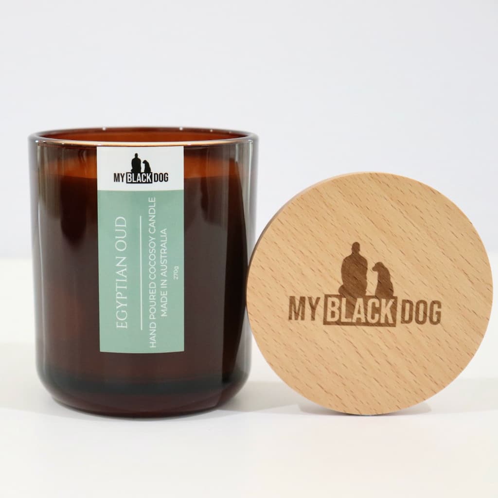 My Black Dog Egyptian Oud CocoSoy Candle in an amber jar with a natural timber lid