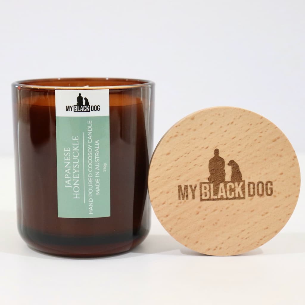 My Black Dog Japanese Honeysuckle CocoSoy Candle in an amber jar with a natural timber lid