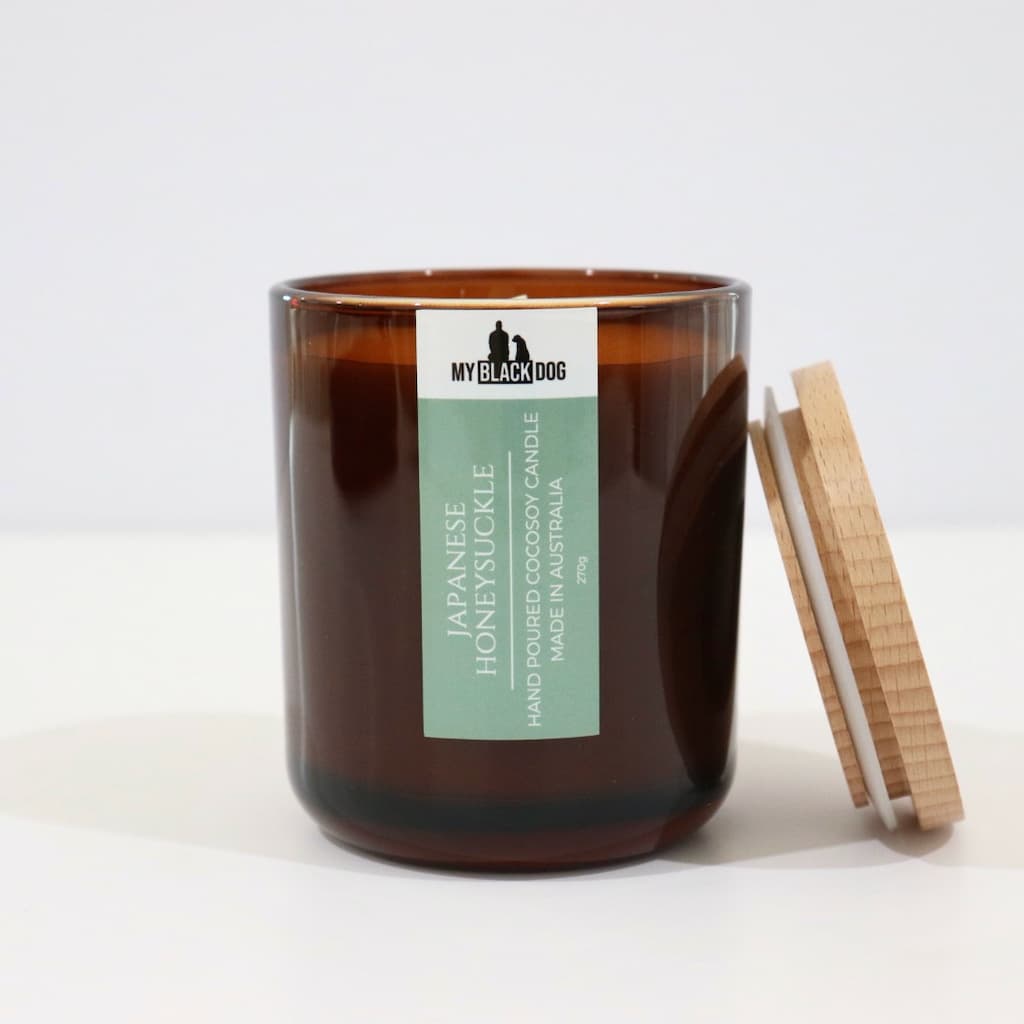 My Black Dog Japanese Honeysuckle CocoSoy Candle in an amber jar with a natural timber lid