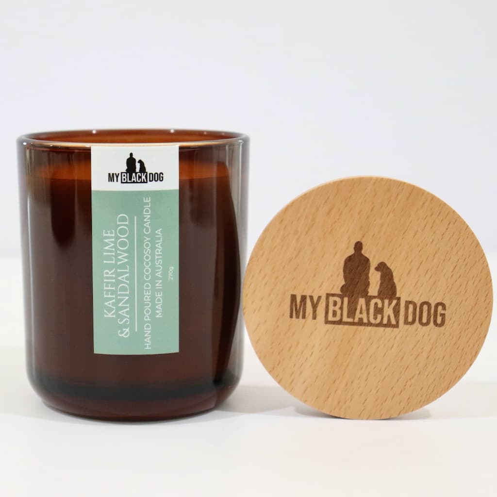 My Black Dog Kaffir Lime & Sandalwood CocoSoy Candle in an amber jar with a natural timber lid