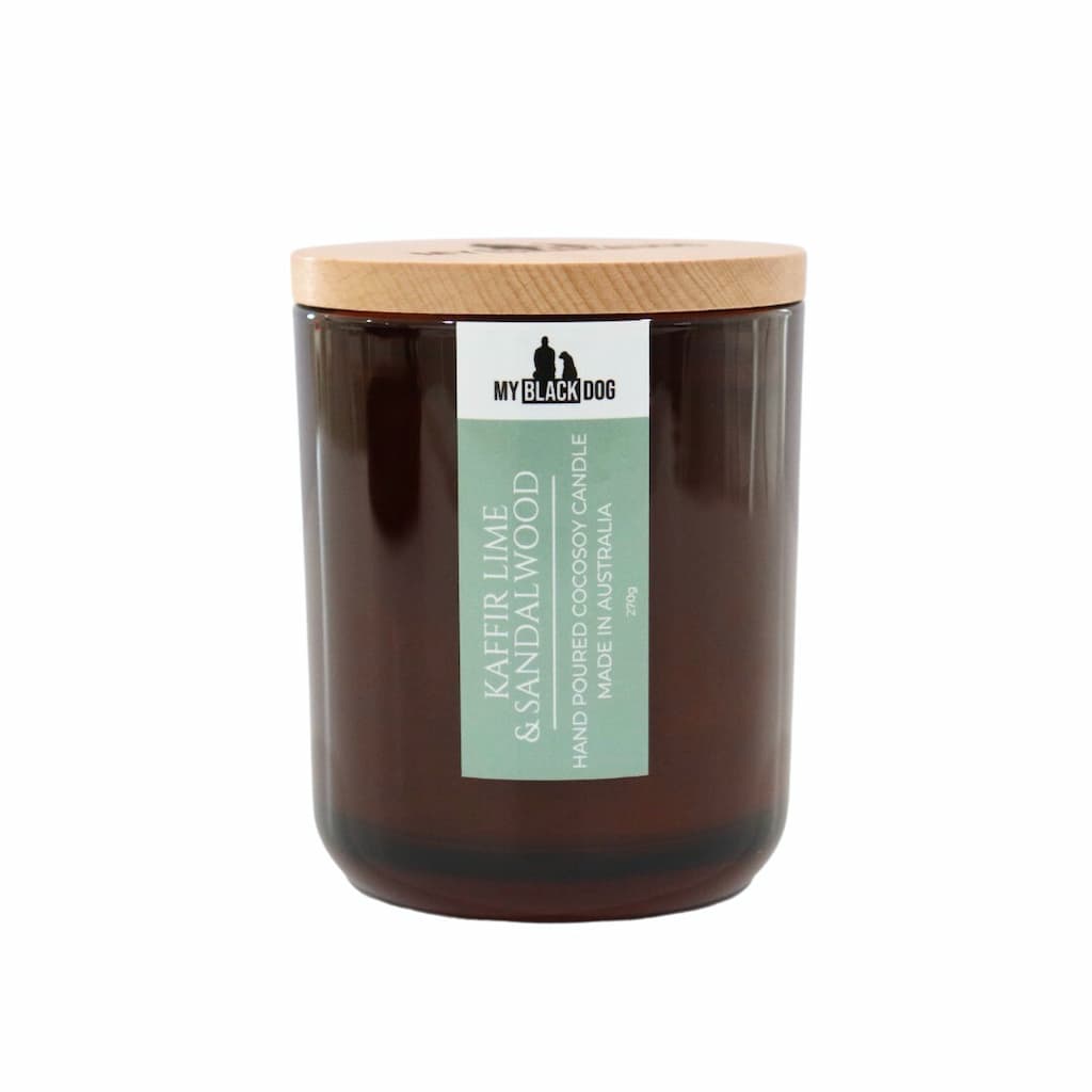 My Black Dog Kaffir Lime & Sandalwood CocoSoy Candle in an amber jar with a natural timber lid