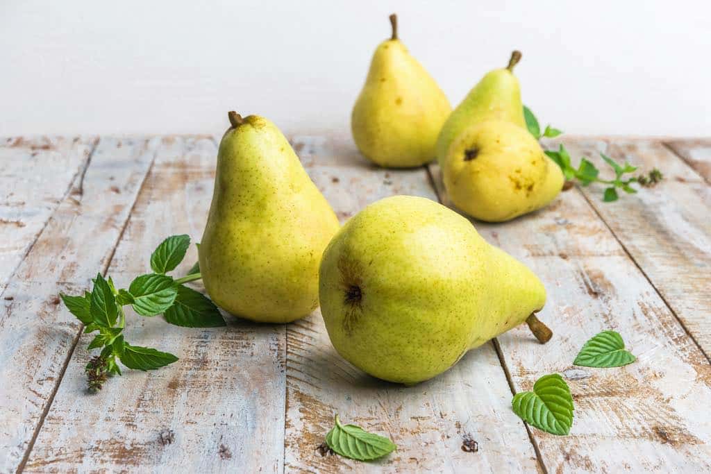Pears sitting on wooden table
